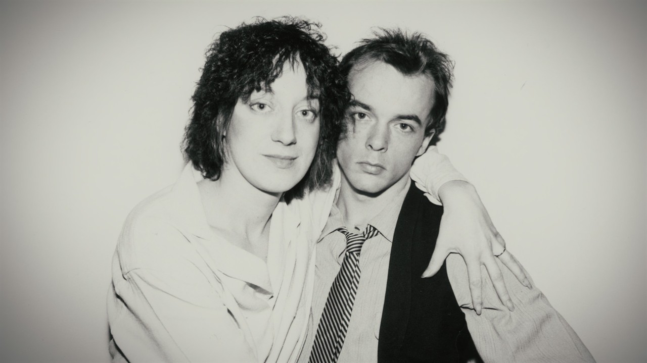 Young Carol Pope with her arm around a man